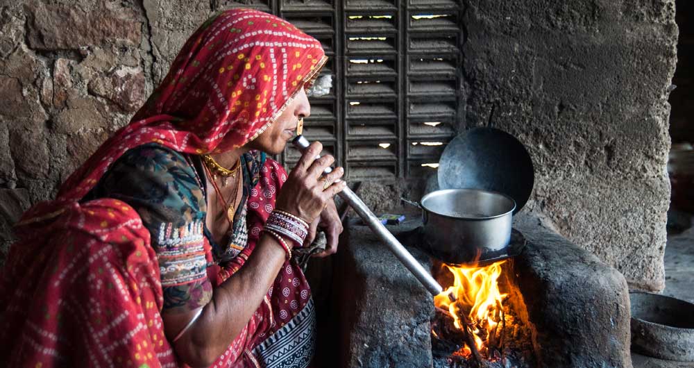 A village woman cooking on a clay stove